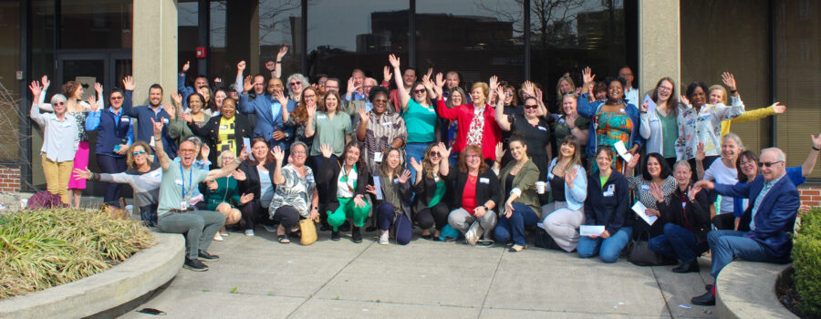 grant recipient individuals pose outside a building